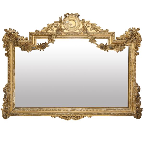 Mirror in gilded wood, eclectic style, with floral friezes, garlands