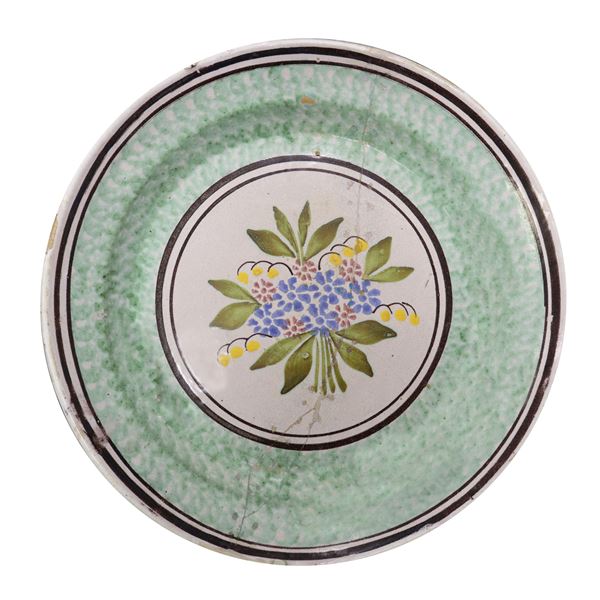 Caltagirone majolica plate, in the center a bunch of polychrome flowers