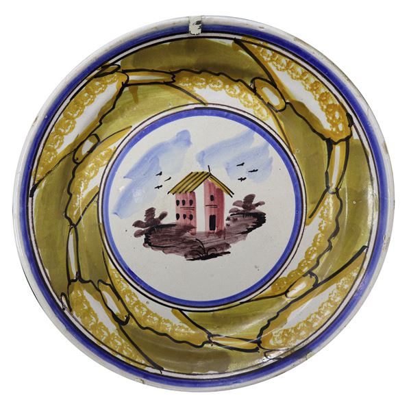 Caltagirone majolica plate, painted with a house in the centre