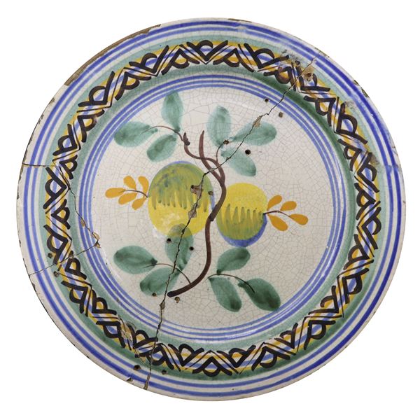 Caltagirone majolica plate painted in the center with a pair of yellow fruits