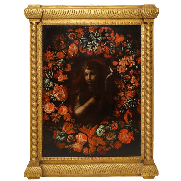 Portrait of a boy with a garland of red flowers.