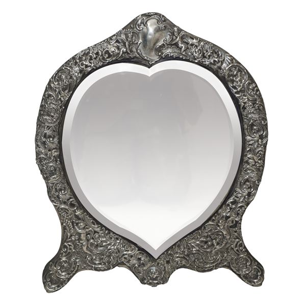 Refined English table mirror with hand-embossed silver frame.