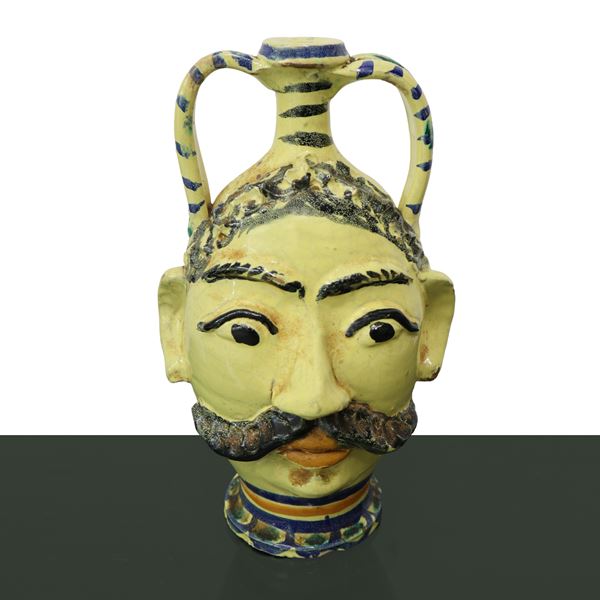 Majolica flask in Caltagirone depicting a male face