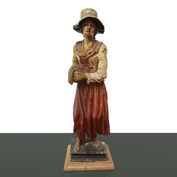 Donna con sacco in mano in legno policromo