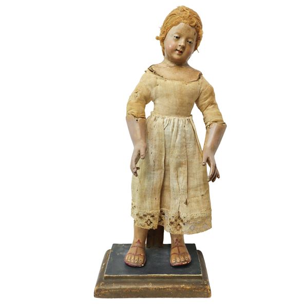 Figurine with terracotta ends, glass eyes, applied hair and fabric clothes