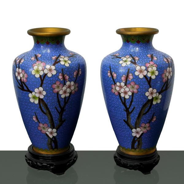 Pair of cloisonne vases with a blue background with peach blossoms and golden decorations