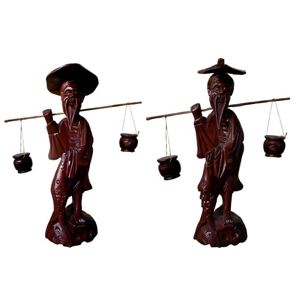 Pair of oriental wooden figurines of an elderly fisherman with hanging baskets