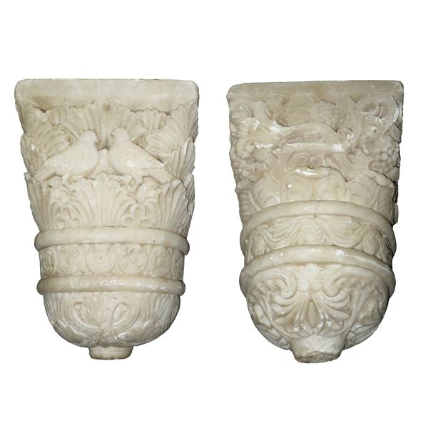 Pair of built-in shelves in white marble carved with acanthus leaves and floral styles