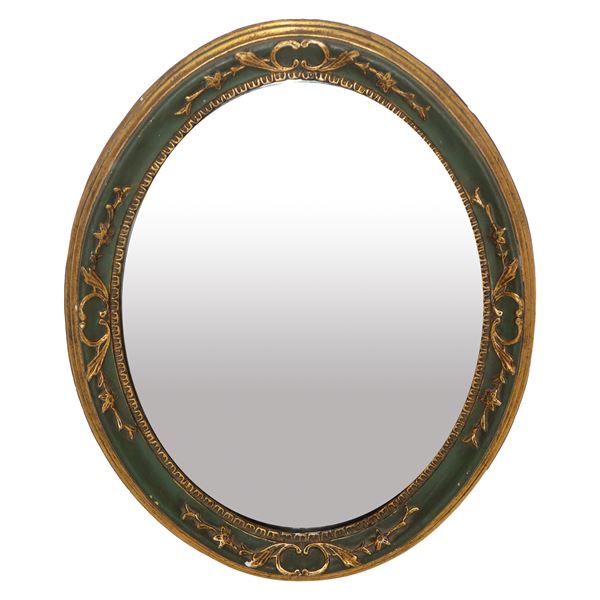 Oval mirror, lacquered and gilded frame
