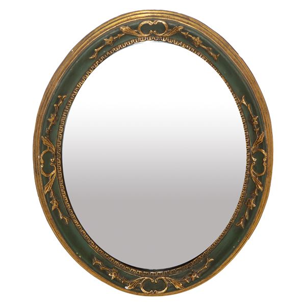 Oval mirror, lacquered and gilded frame