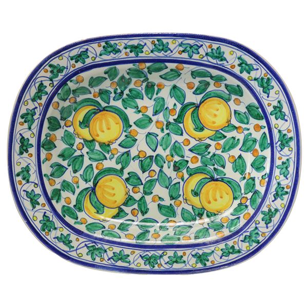 Oval wall plate on a white base with representations of lemons