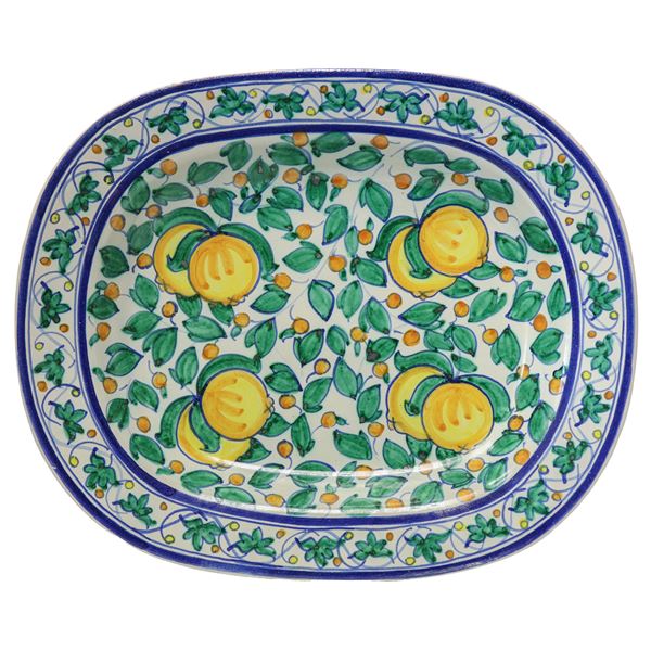 Oval wall plate on white base with lemons