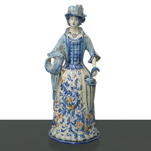 Lumiera with female depiction of woman with umbrella in Caltagirone majolica