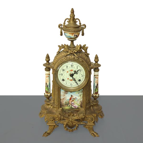 Gilded bronze table clock with porcelains applied to the center and sides