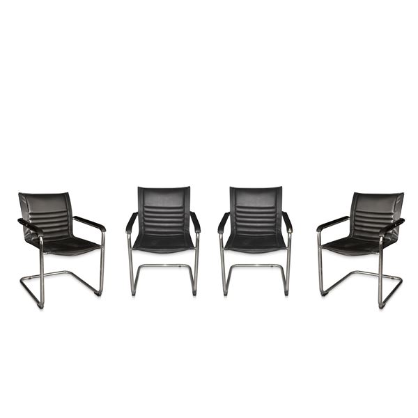 Four vintage chairs produced. Italy in black leather with chromed tubular base