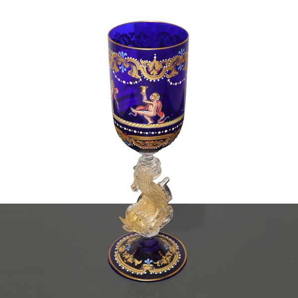 Murano glass glass with gold decorations on a blue background