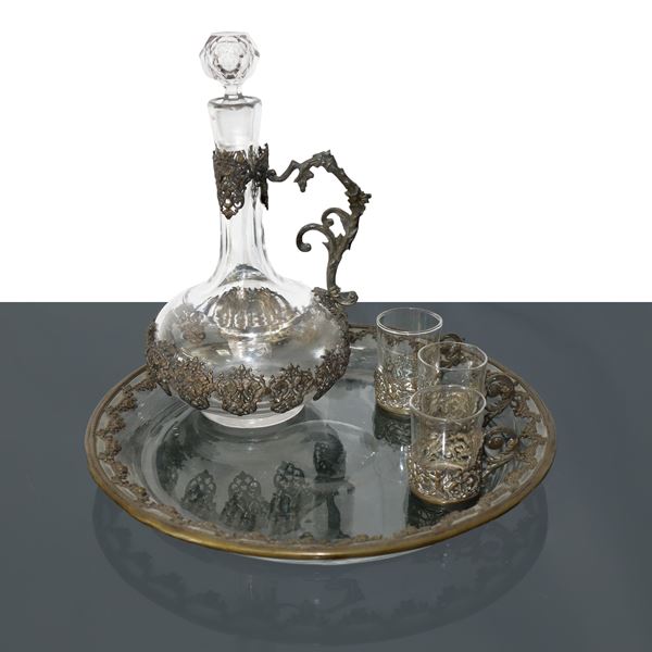 Plate with glass bottles and liqueur glasses with brass decoration
