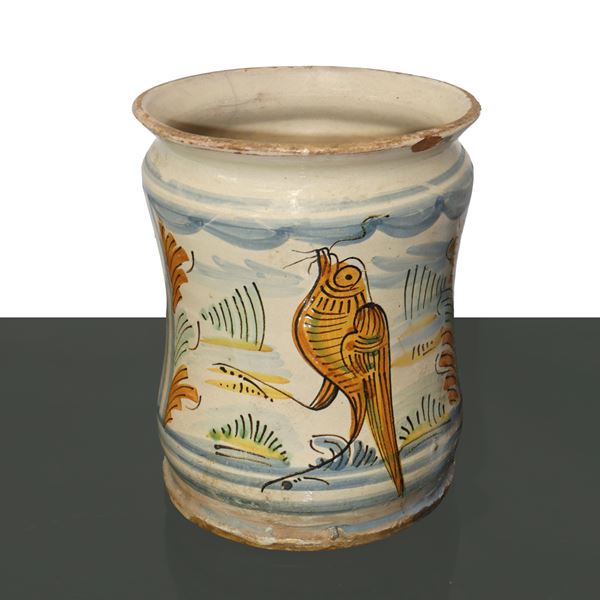 Polychrome majolica cylinder in shades of blue and antimony yellow.