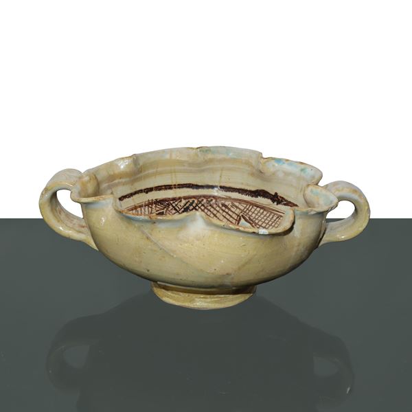 Double-handled and wavy cup with female figure