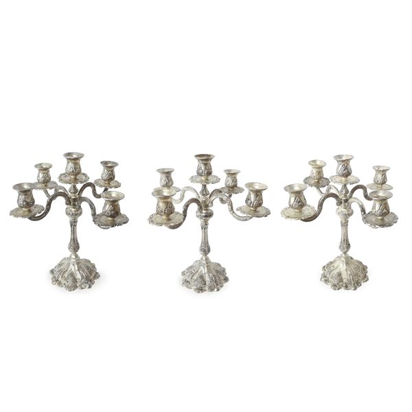 Three 5-flame candlesticks in silver-plated nickel silver metal with applications and floral decorations in relief.
