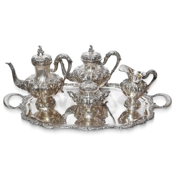 Silver service consisting of tray, teapot, coffee pot, milk jug in embossed and engraved silver with decoration of leaves and shells