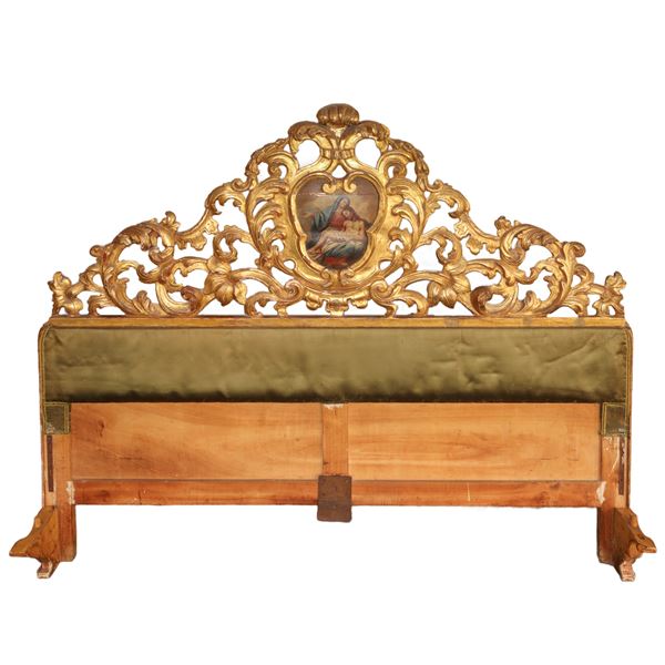 Bed with headboard and footboard in gilded wood and headboard with central painting of the Madonna with Jesus 