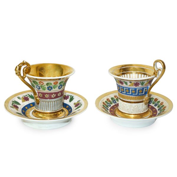 Pair of Empire cups and saucers in golden porcelain in ormolu and polychrome plant decorations