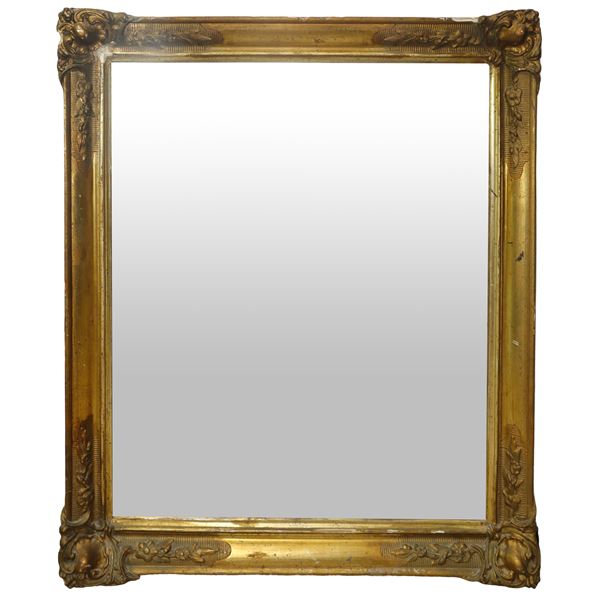 Rectangular mirror in gilded wood with tablet application on the corners