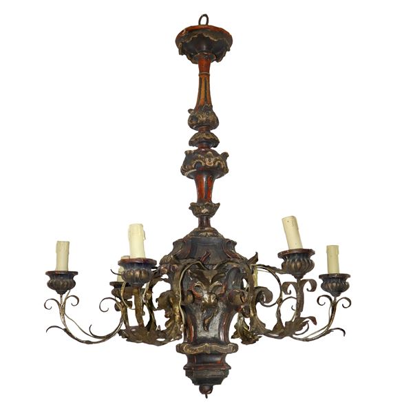 6-light chandelier with carved wooden stem and golden metal arms shaped like leaves