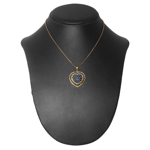 18kt yellow gold and sapphire heart pendant with gold necklace.