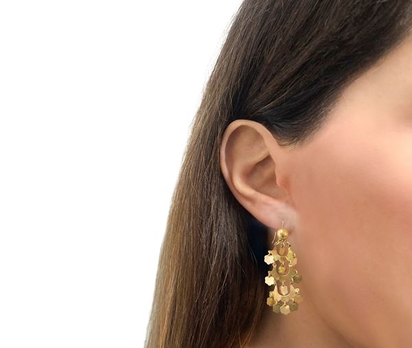 Low title gold pendant earrings with flower-shaped pendants