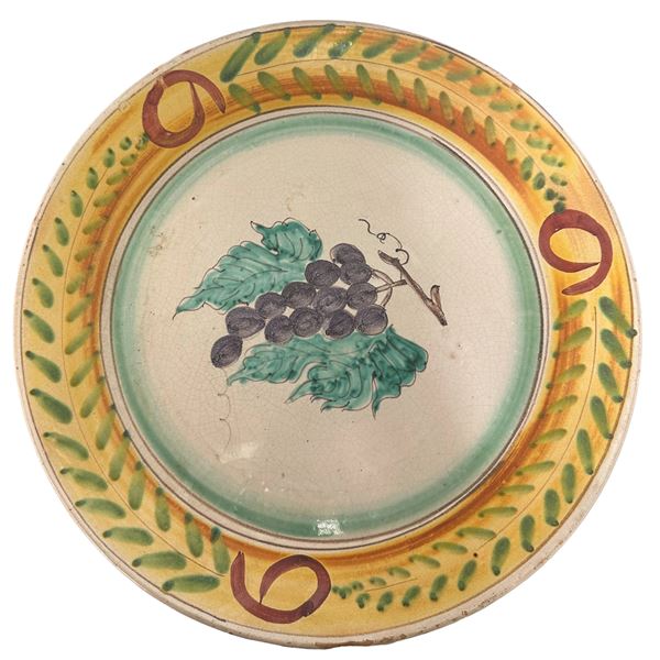 Large polychrome majolica plate depicting grapes with leaves in the centre Santa Stefano di Camastra