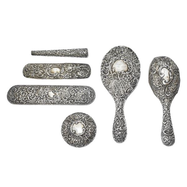 Group composed of 6 covers for toilet objects in hand-worked and embossed silver 