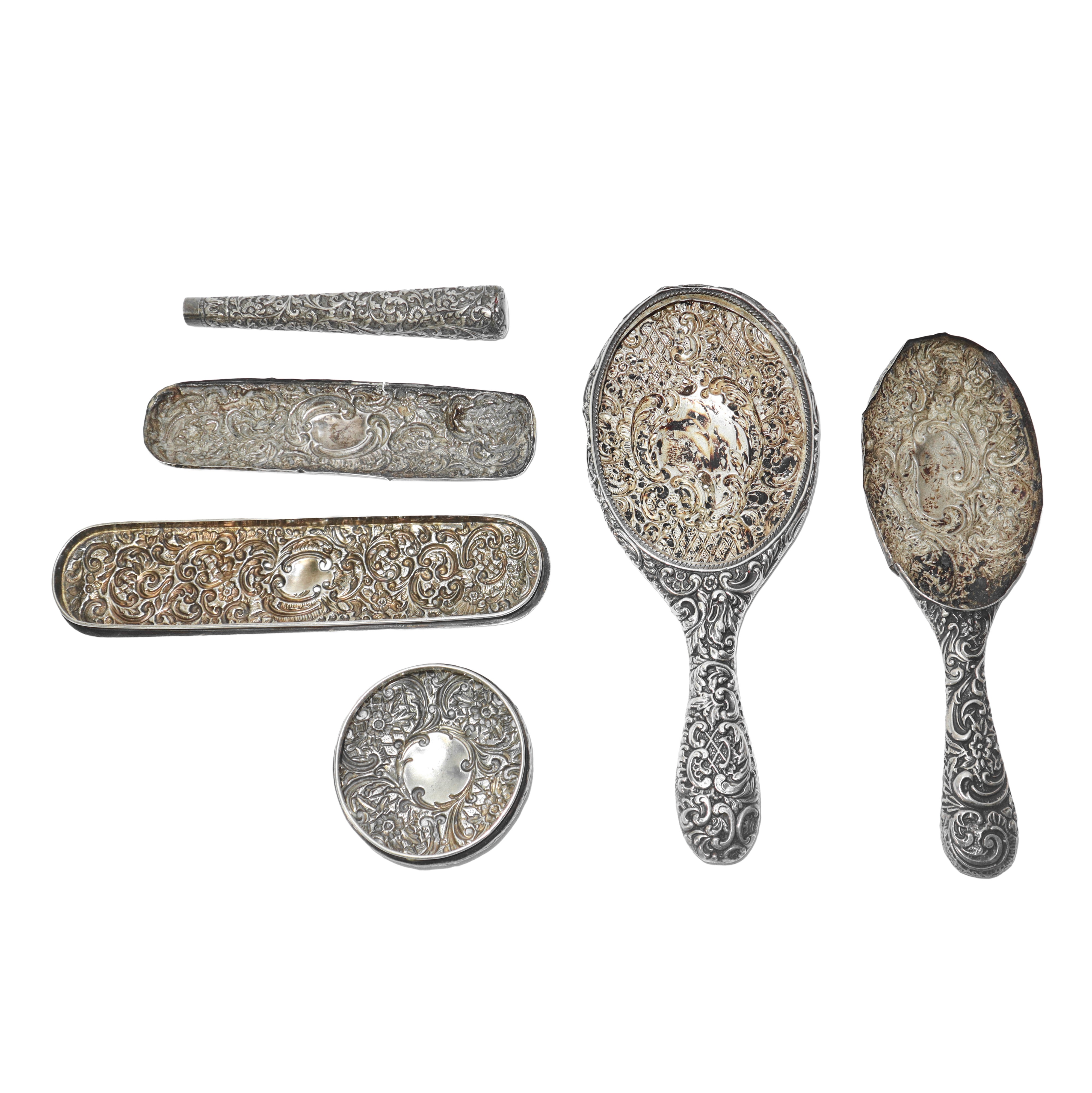 Gruppo composto da n°6 rivestimenti per oggetti da toletta in argento lavorato e sbalzato a mano