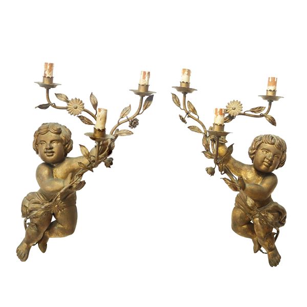 Pair of three-light candle holder cherubs in gilded wood