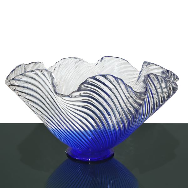 Clear glass centerpiece with wavy edge and blue background