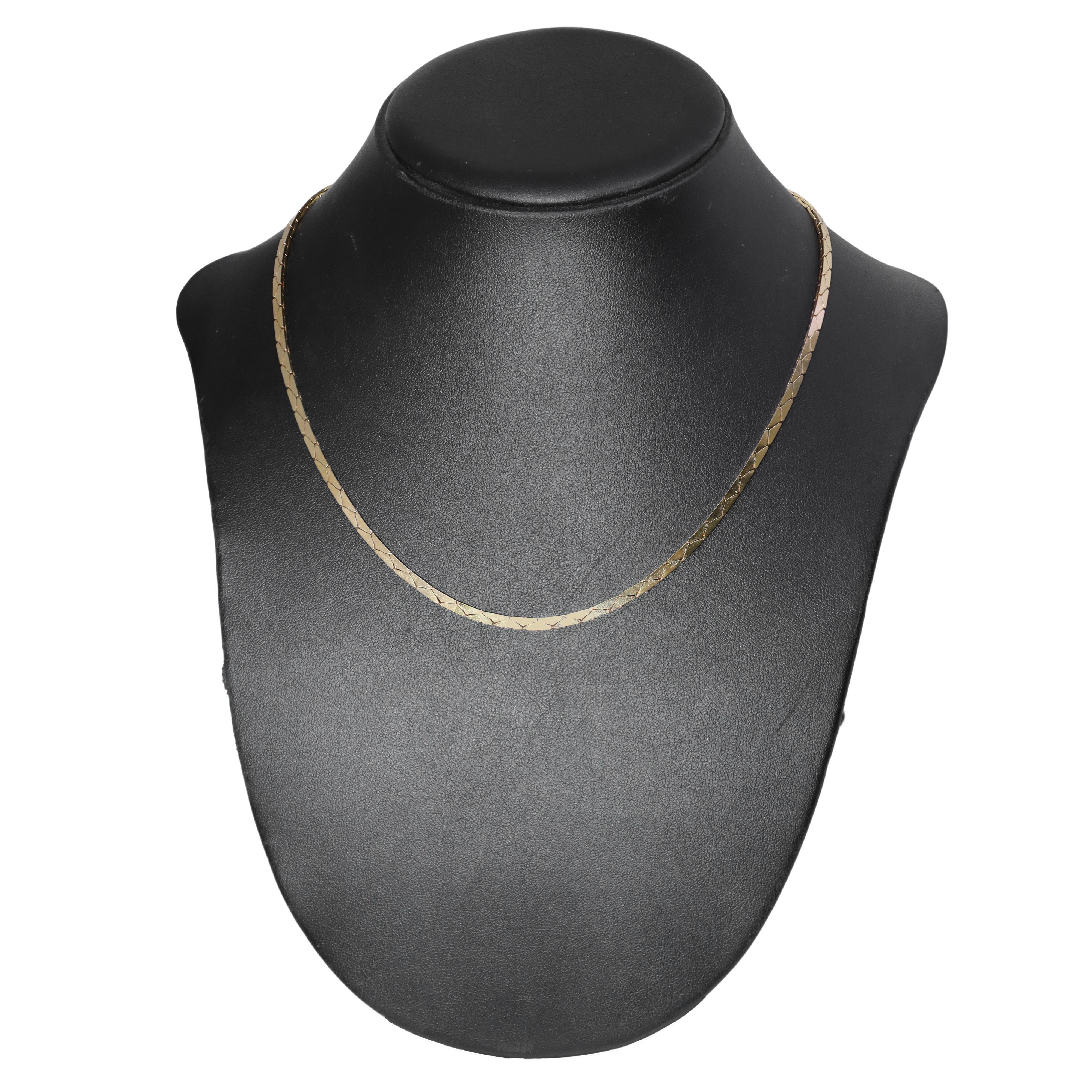 Parure con catena dorata a maglie triangolari composta da collana e bracciale