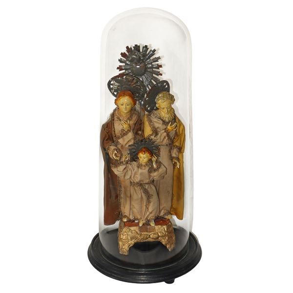 Holy family in porcelain under glass case