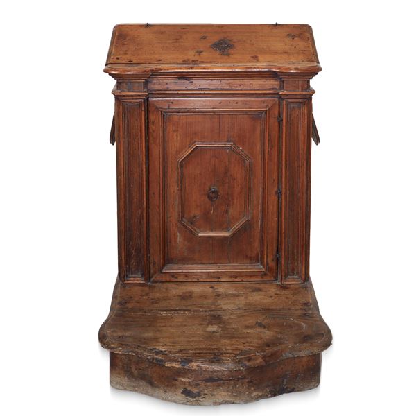 Walnut kneeler with flap at the top and door underneath with pilasters on the sides 