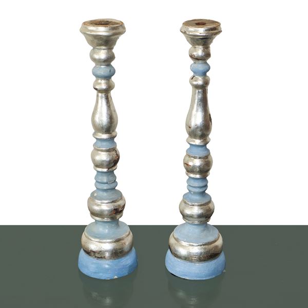 Pair of lacquered and silvered wooden candlesticks