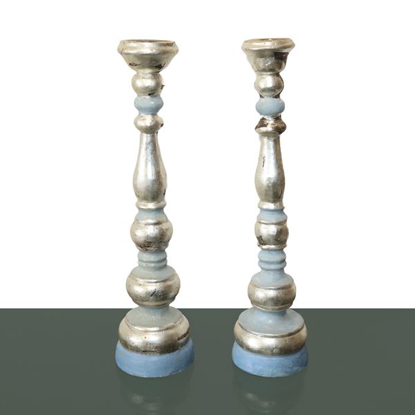 Pair of lacquered and silvered wooden candlesticks