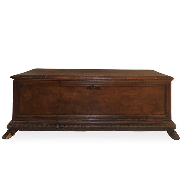 Solid walnut chest on the front perimeter frame with cuspidate denticulation, carved base, feline feet