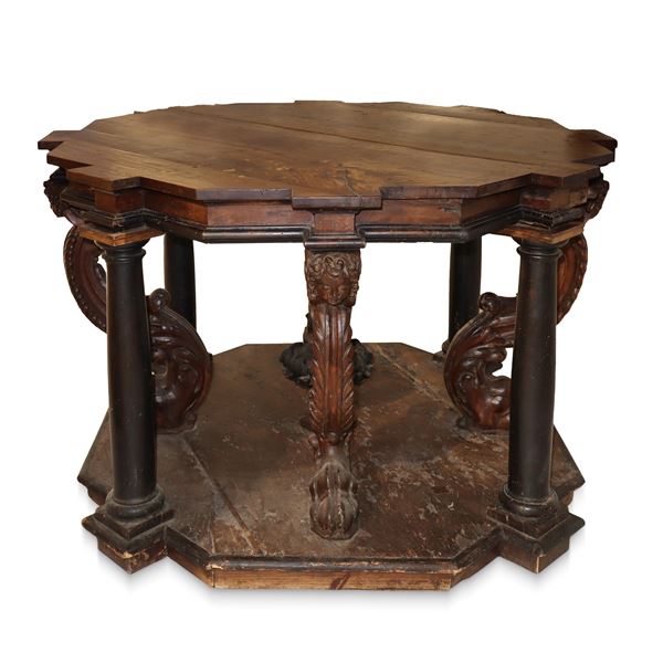 Solid walnut table with jagged top, octagonal base, carved and sculpted legs, lion&#39;s foot