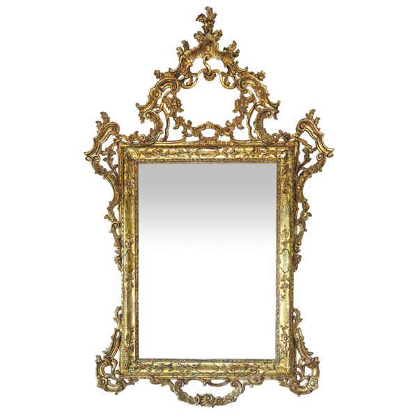 Rococo mirror with gilded and carved wooden top and sides 