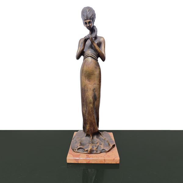Woman with braid, bronze sculpture.