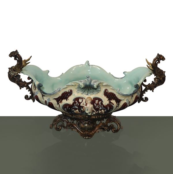 Large majolica centrepiece with metal base and handles with griffin depictions