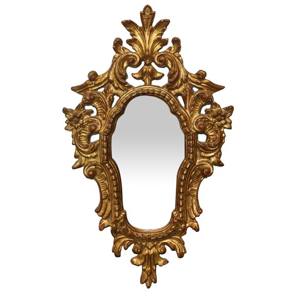 Carved and sculpted gilded wooden mirror