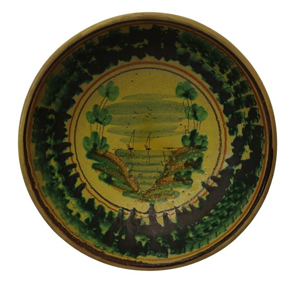 Caltagirone plate in decorated and enameled majolica with a depiction of boats