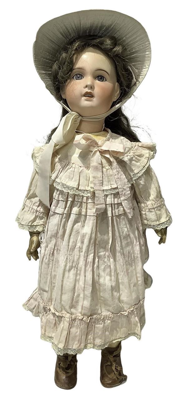 Doll in biscuit porcelain and body in composite material, pink dress with polka dots, real hair, googly eyes, no. 6 teeth, French type articulated limbs, S.F.B.J. signature Paris 11, 1905 about, France origin, h 68 cm