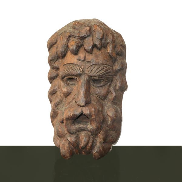 Wooden sculpture depicting a carved and sculpted face